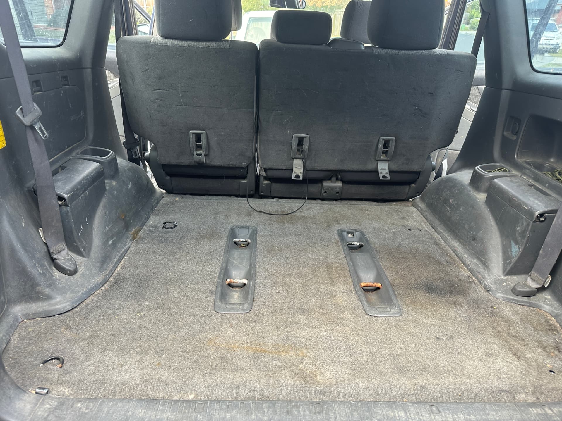 Before — Toyota Prado rear cargo area before and after a deep interior clean