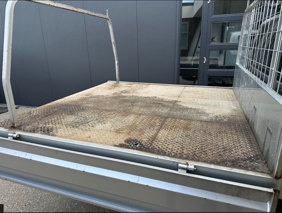 Before — Diamond-plate work ute tray before and after a professional clean