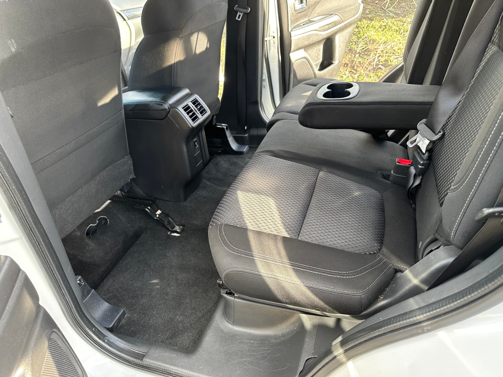 After — Mitsubishi Outlander rear seats and floor before and after an interior detail