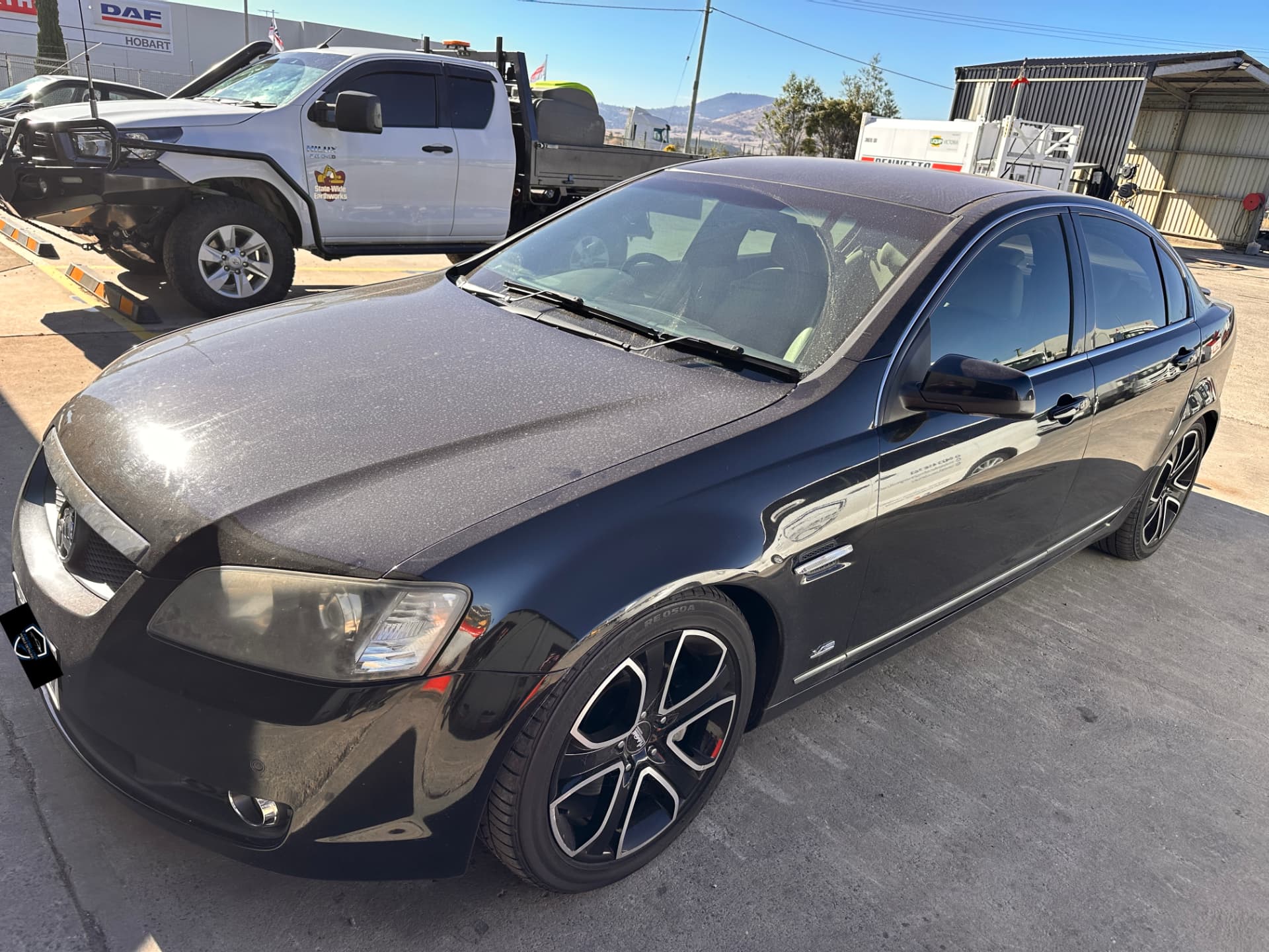 Before — Black Holden Commodore before and after a cut and polish in Hobart