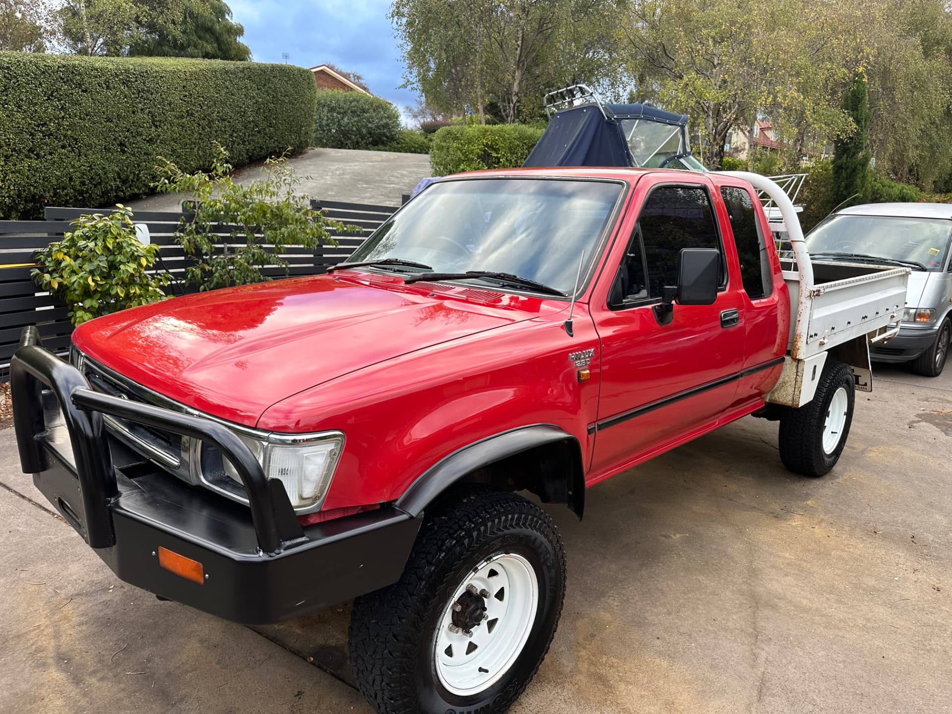 After — Red Toyota Hilux with faded paint before and after a cut and polish
