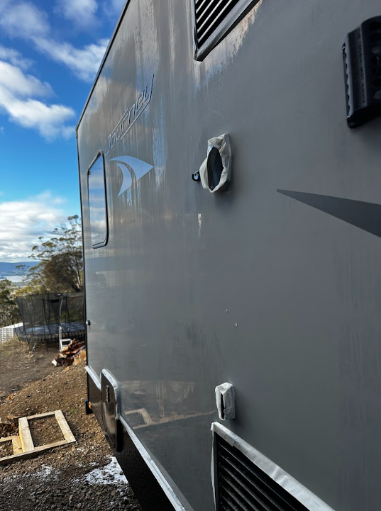 Before — Grey Jayco Journey caravan panel before and after a machine polish