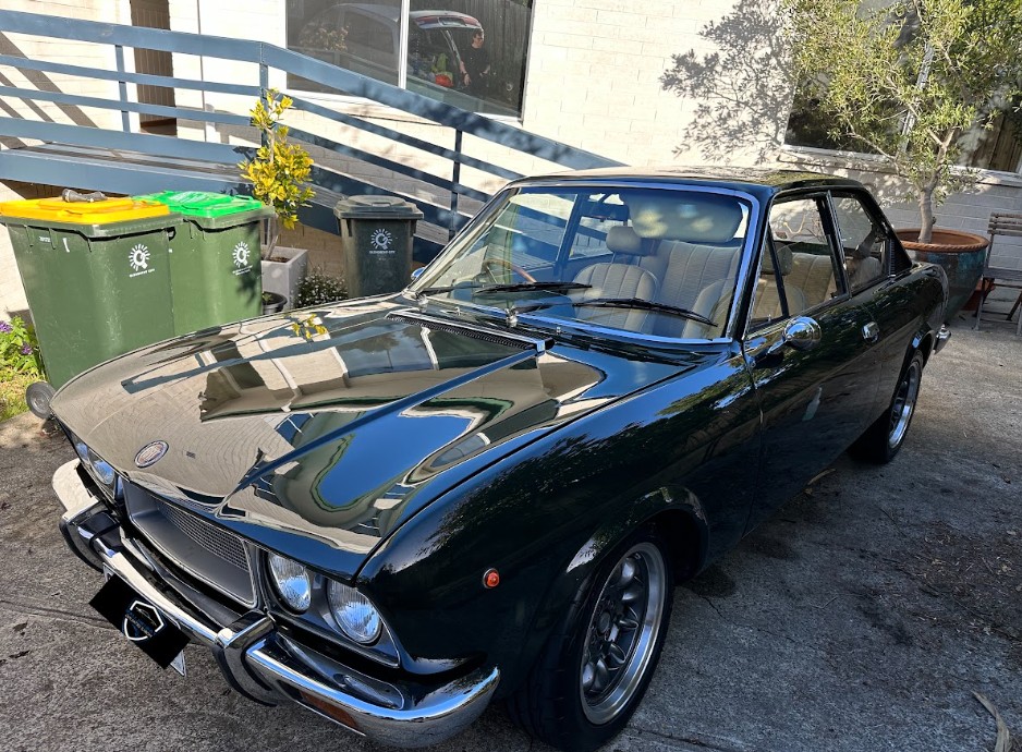 Classic green Fiat coupe detailed to a mirror finish