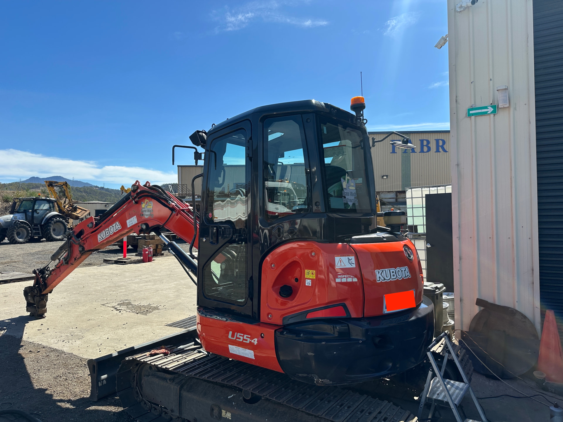 After — Kubota U55-4 excavator rear before and after cleaning and polishing