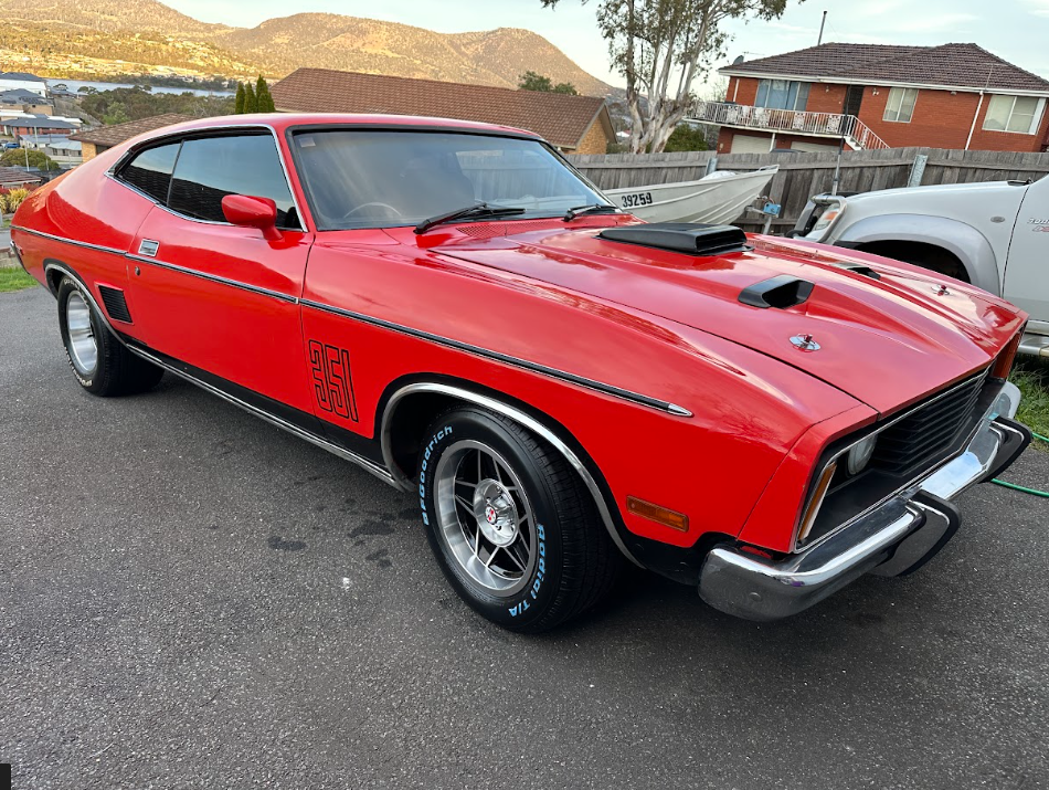 Classic red Ford Falcon coupe detailed to a deep gloss