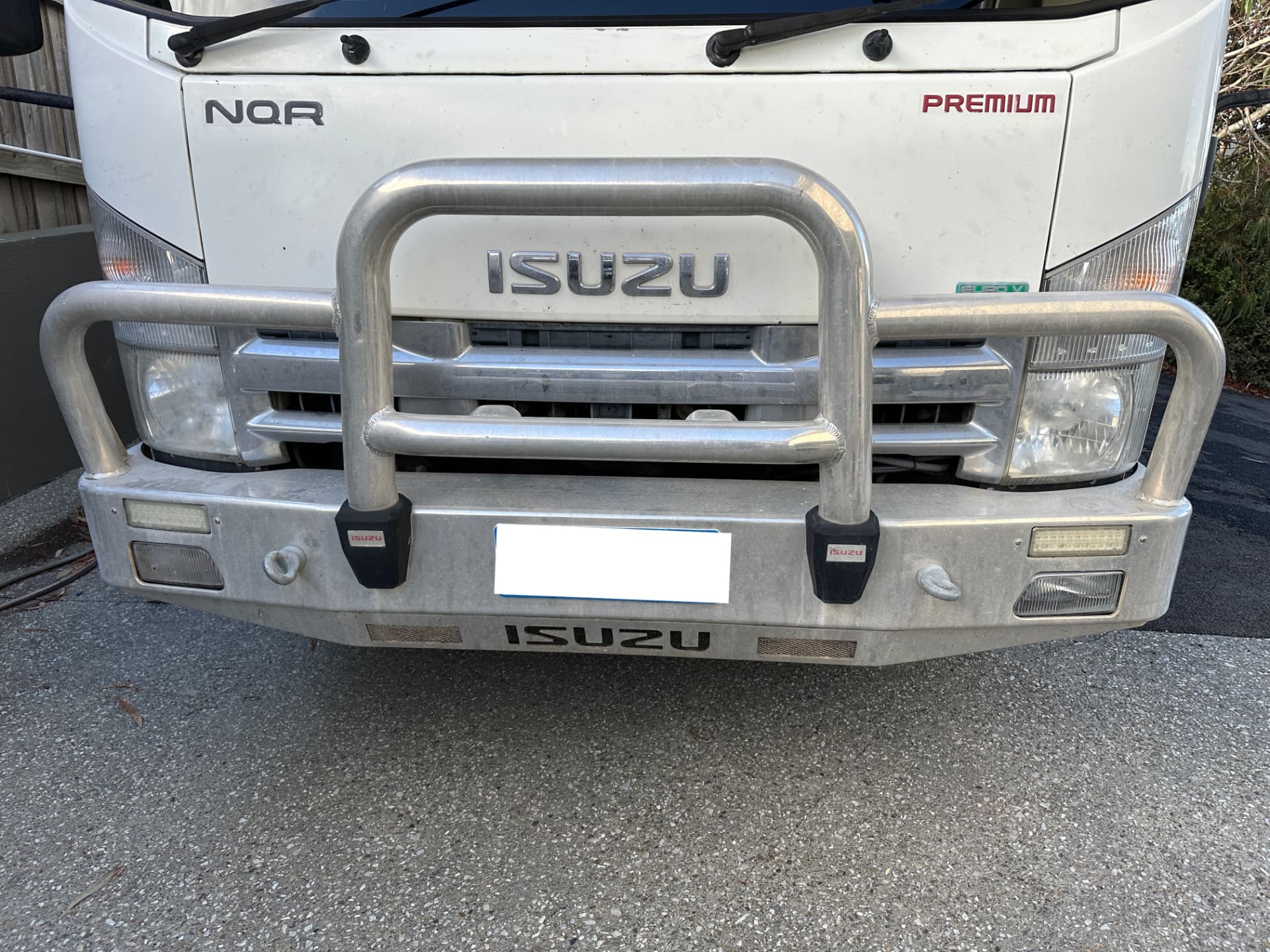 Before — Isuzu NQR truck bull bar before and after a metal polish restoration